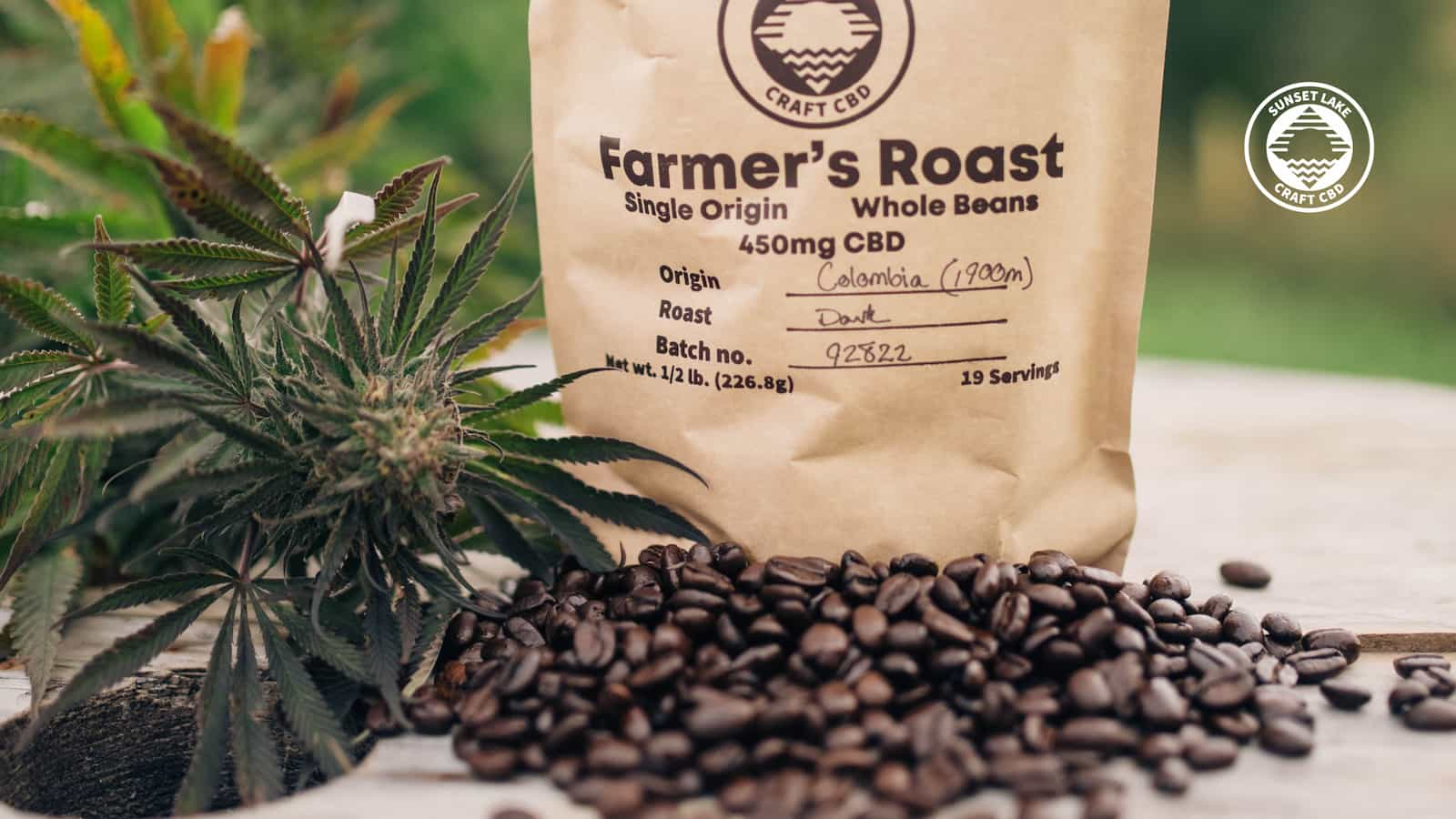 A bag of CBD-infused coffee beans next to hemp flower