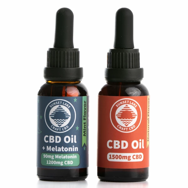 Two one-ounce amber dropper bottles next to each other. The right is the 1500mg Full Spectrum CBD Oil Tincture and the left is the 1200mg Full Spectrum CBD Oil + Melatonin
