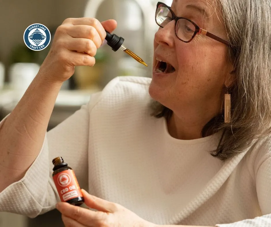 A woman putting CBD oil under her tongue