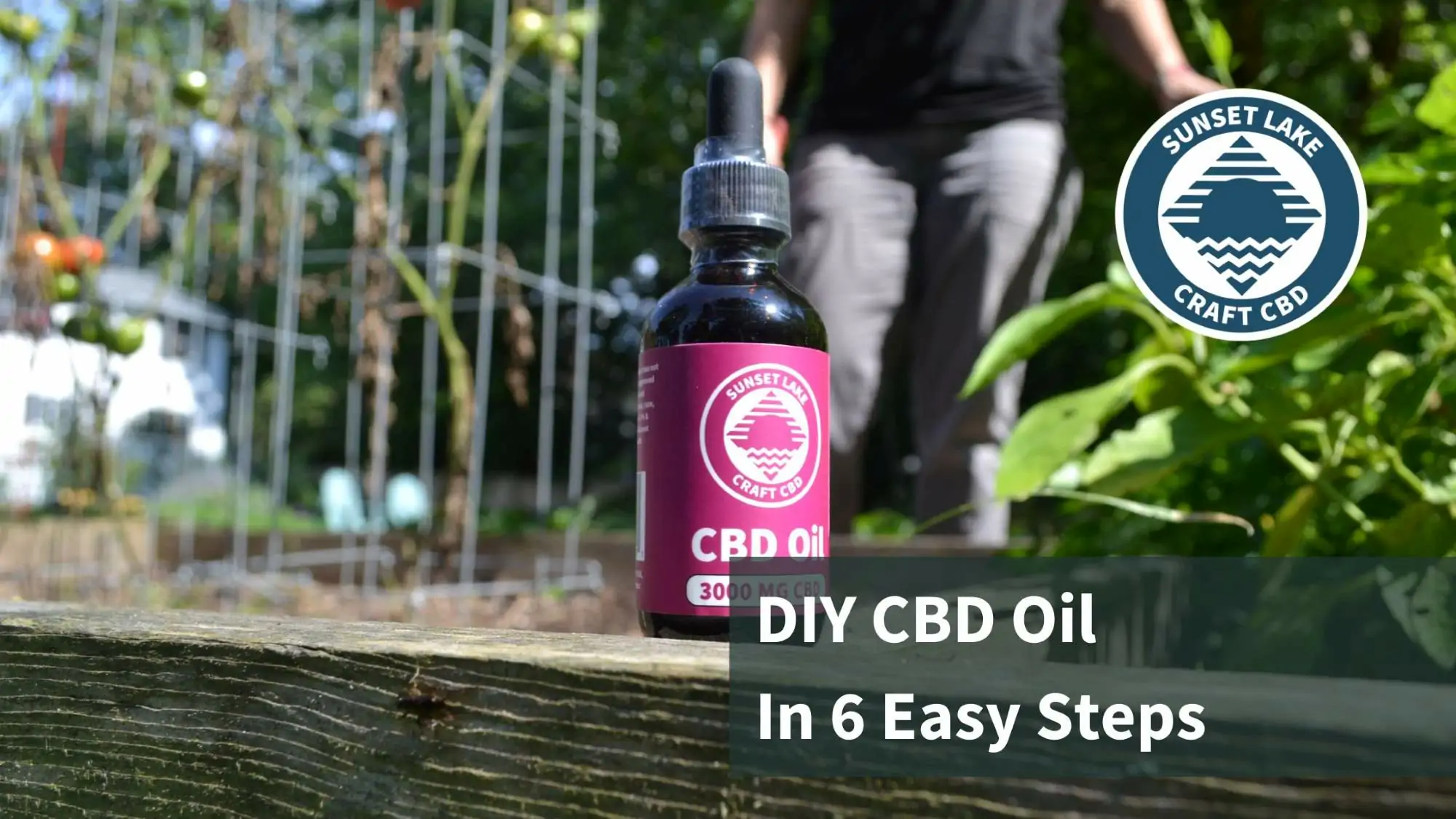 CBD oil sitting on the edge of a garden bed