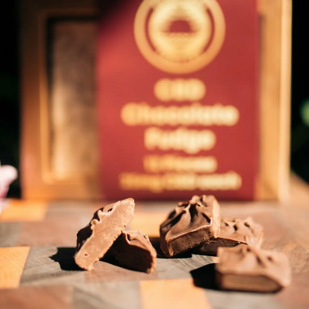 CBD Chocolate Fudge halved and stacked on a cutting board