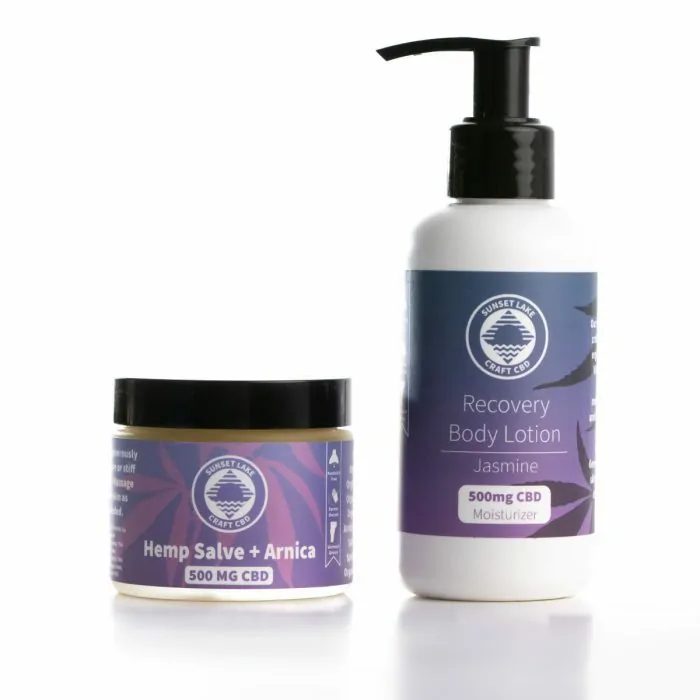 A 500mg full spectrum CBD salve next to a four ounce bottle of Jasmine CBD lotion from Sunset Lake CBD