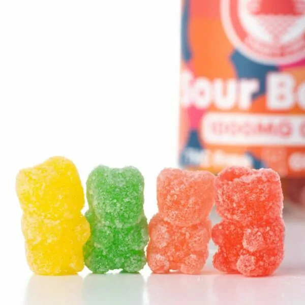 Four different colored Sour Bears lined up