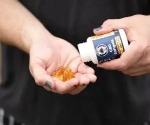 Pouring CBD Softgels from bottle into hand